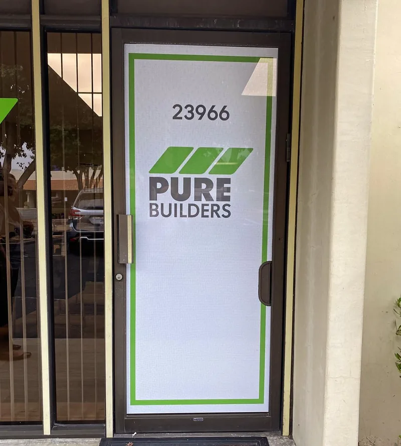 Pure Builders logo and green border printed on an office entrance door